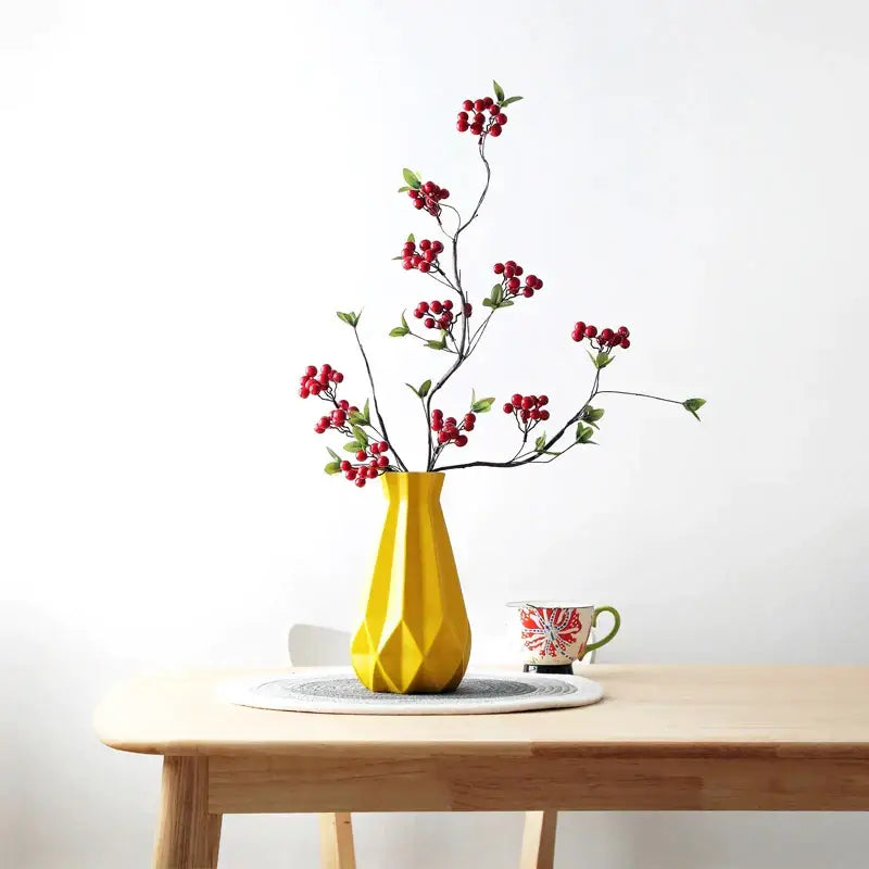 Vibrant yellow decorbites ceramic diamond vase holding artificial red berry branches for modern living room decor