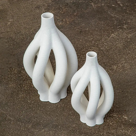 White geometric ceramic spiral vases with intricate twisted design for modern living room decor by decorbites
