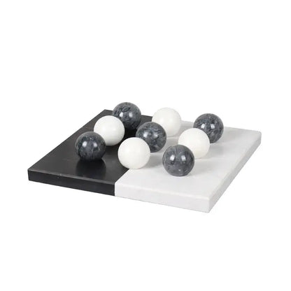 Modern geometric chess ornament set with black and white marble checkers and glossy spherical pieces for home decor