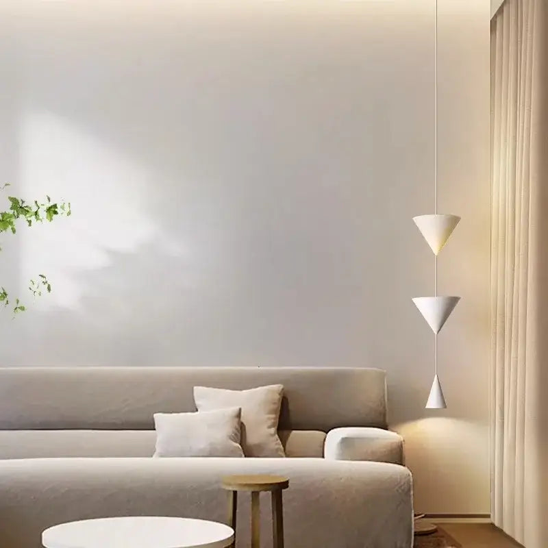 A modern white geometric decorbites cone long led pendant light with three stacked triangular shades for bedroom use