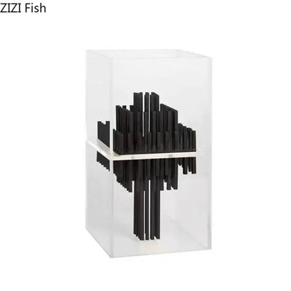 Black abstract fish sculpture made of acrylic rods inside a transparent geometric display box for modern living room decor