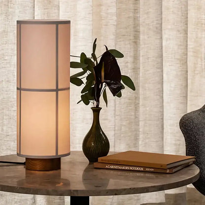 Warm-toned cylindrical table lamp with beige fabric shade and wooden base for modern geometric decorbites hashira cluster pendant light