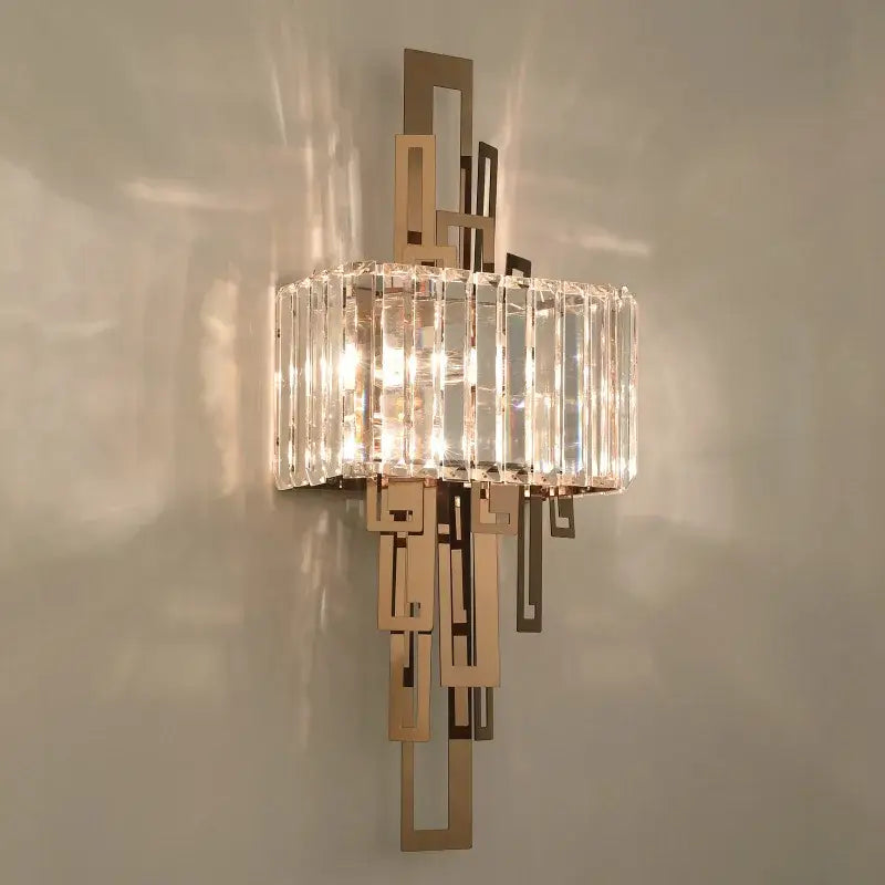 A modern geometric gold crystal wall lamp with brushed metal frame and vertical crystal rods for bedroom decorbites crystal wall use