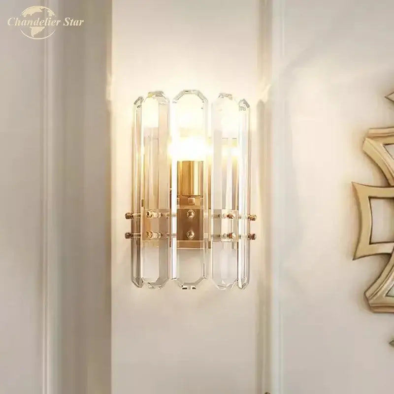 Modern geometric gold crystal wall sconce with clear crystal and gold-toned metal accents for nordic wall lighting