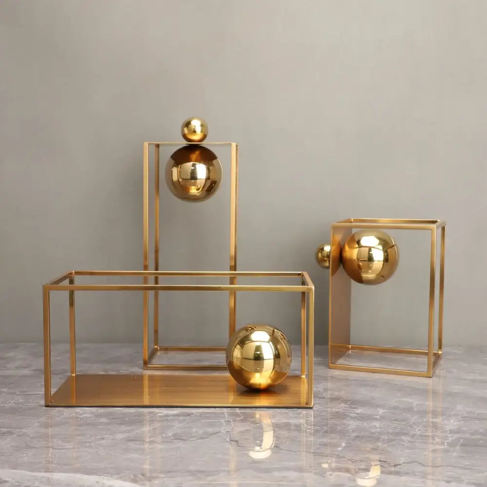 Golden metallic geometric gold frame decorative figurines with reflective spheres in open cube frames for living room decor