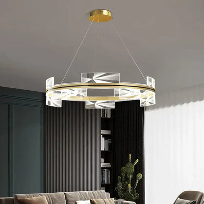 Modern geometric gold led pendant lights featuring a circular gold-toned metal frame with clear crystal accents