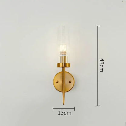 Modern geometric gold metal glass pendant light featuring a gold-toned wall sconce with illuminated bulb decorbites gold metal