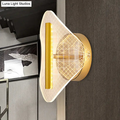 Modern geometric gold sconce light with translucent patterned diffuser and illuminated vertical strip for living room