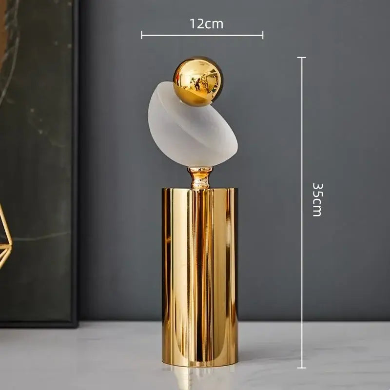 Modern geometric golden ball sculpture with polished base, frosted glass curve, and reflective golden ball for living room decor