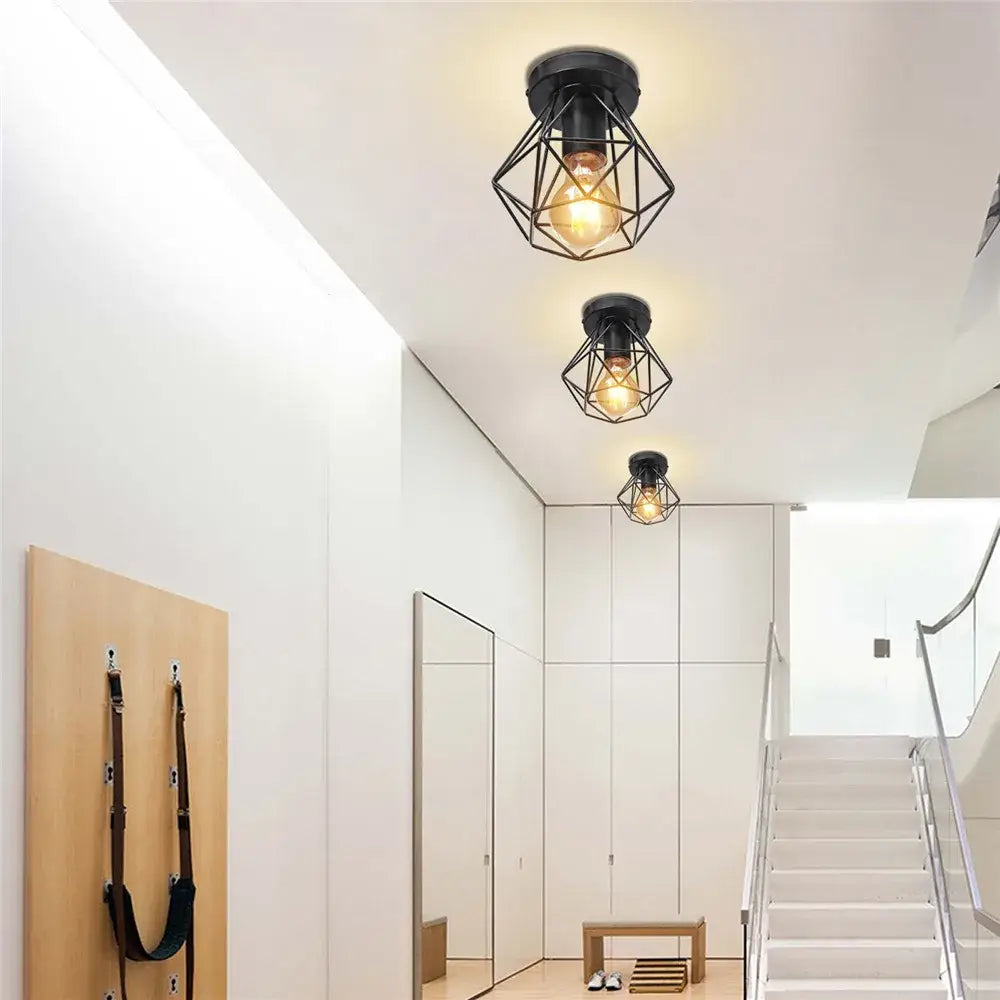 Modern geometric iron frame cage ceiling light in black with exposed filament bulb for aisle and loft decorbites iron frame