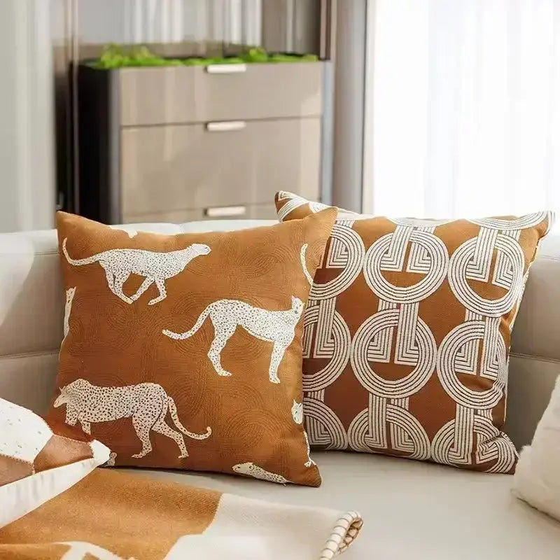 Brown cushion cover with white embroidered cheetah silhouettes and decorbites geometric jacquard pattern for living room decor