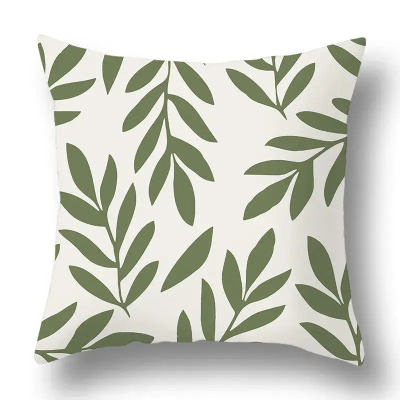 A modern geometric print pillow cover featuring olive green decorbites green plants on a white background