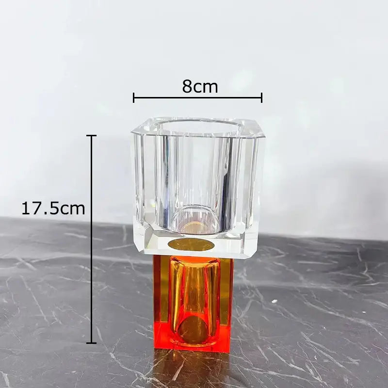 Clear faceted acrylic vase with vibrant orange base and gold accent on square platform for decorbites geometric square artificial flowers decor
