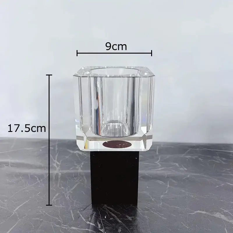 Clear faceted crystal candle holder with black base complementing decorbites geometric square artificial flowers decor