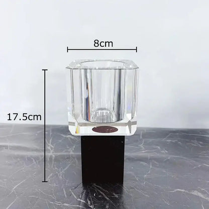 Clear faceted glass candle holder with black base complementing decorbites geometric square artificial flowers decor