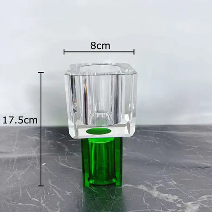 Clear crystal vase with green base and faceted design holding geometric square orange and blue artificial flowers decorbites geometric square decor