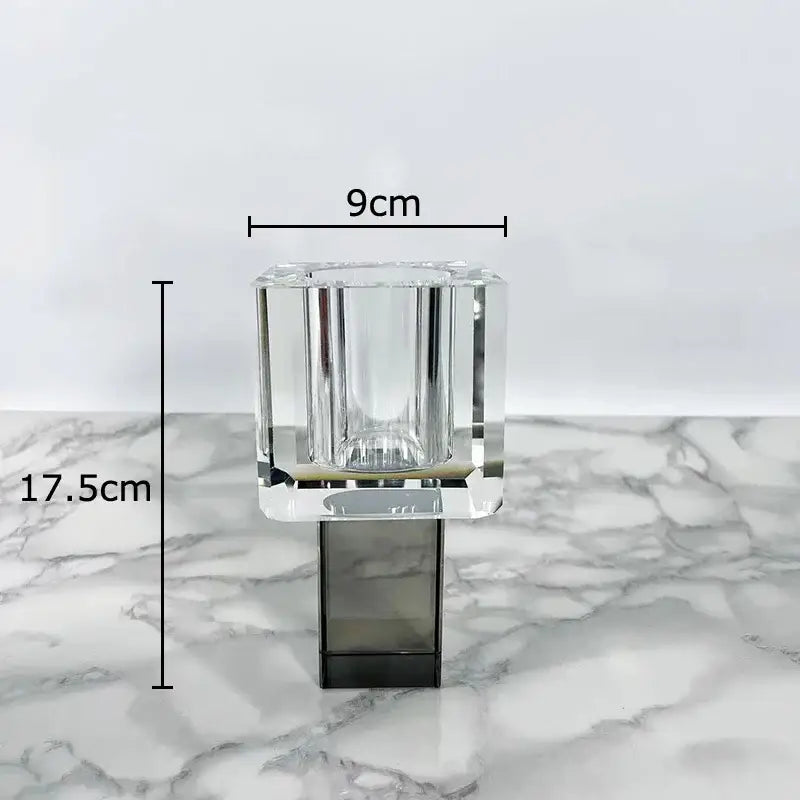 Clear crystal candle holder with faceted geometric design and sleek black base for modern geometric square artificial flowers decorbites display
