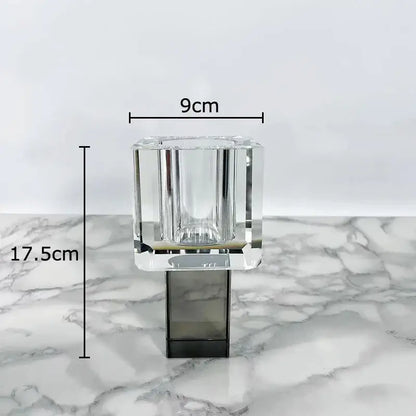 Clear crystal candle holder with faceted geometric design and sleek black base for modern geometric square artificial flowers decorbites display