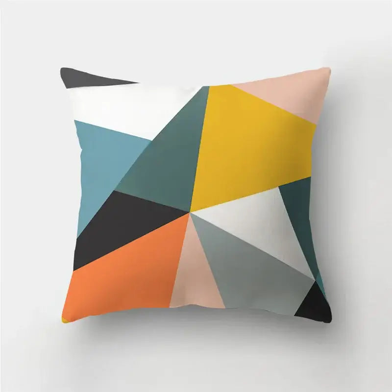 A modern geometric stripe patchwork pillow case with bold yellow, orange, teal, black, white, and pink triangles for living room decor