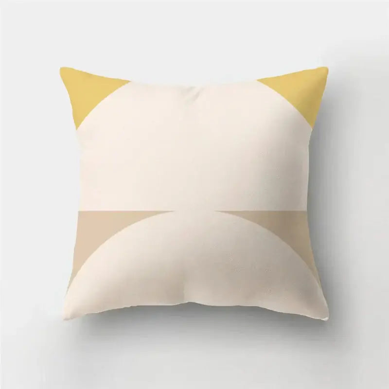 Cream-colored pillow case with modern geometric stripe patchwork featuring mustard yellow triangles for living room decor