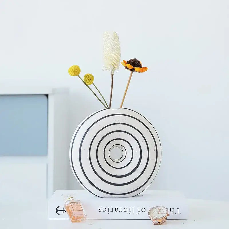 White ceramic vase with black geometric stripes featuring concentric circular patterns for living room decorbites decor