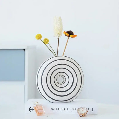 White ceramic vase with black geometric stripes featuring concentric circular patterns for living room decorbites decor