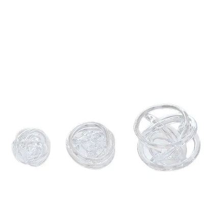 Clear glass coil wound ball with intricate twisted design as modern geometric living room decor orb