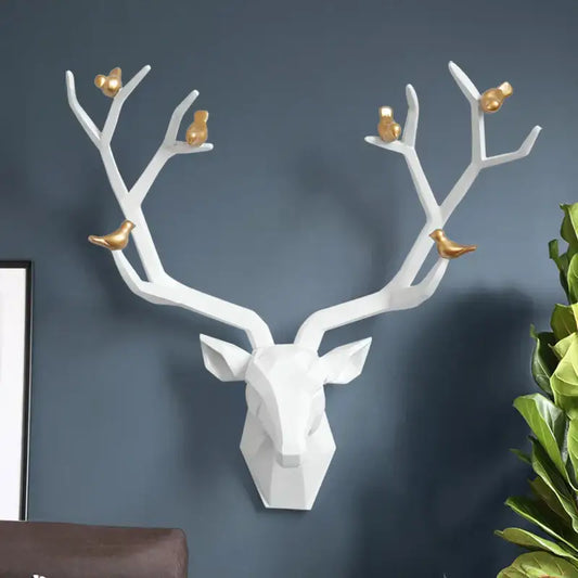 Modern geometric white and gold deer head wall decor with gold birds perched on antlers for living room use