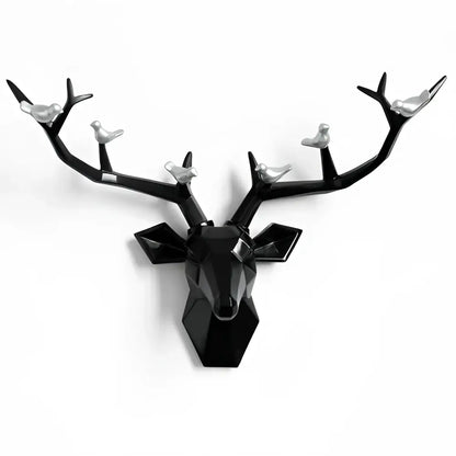 Modern black geometric deer head wall decor with silver birds perched on antlers for stylish living room display