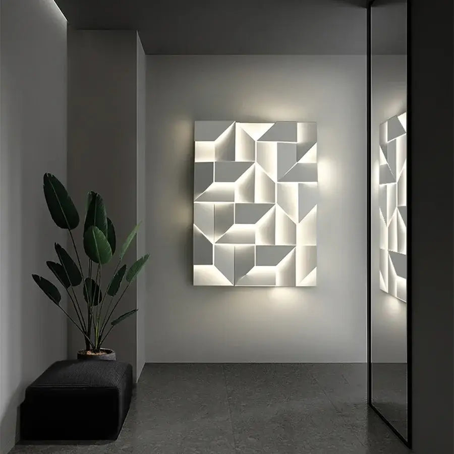 A modern geometric white grand sconce lamp featuring illuminated three-dimensional facets for bedroom decorbites grand sconce