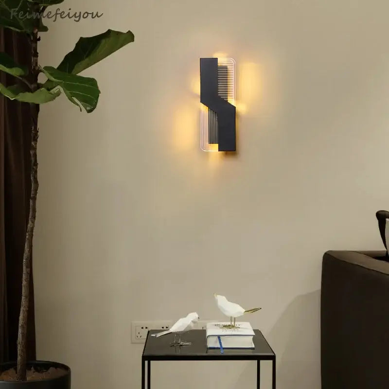 Modern geometric white led wall lamp with black transparent angular wall sconce emitting warm light for led bedroom wall decorbites