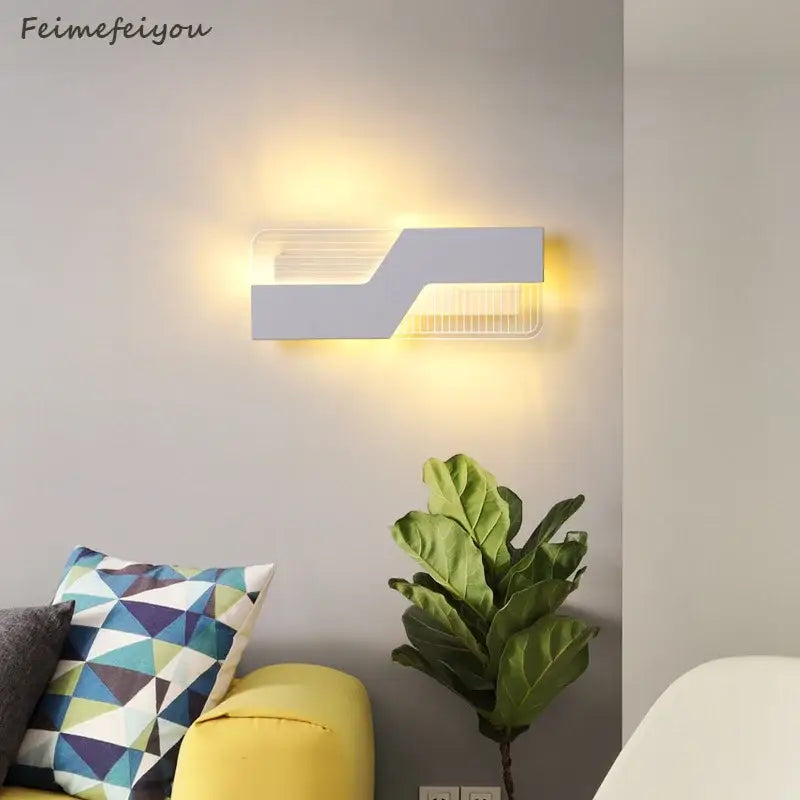 Modern geometric white led wall lamp with warm yellow light ideal for decorbites led bedroom wall lighting