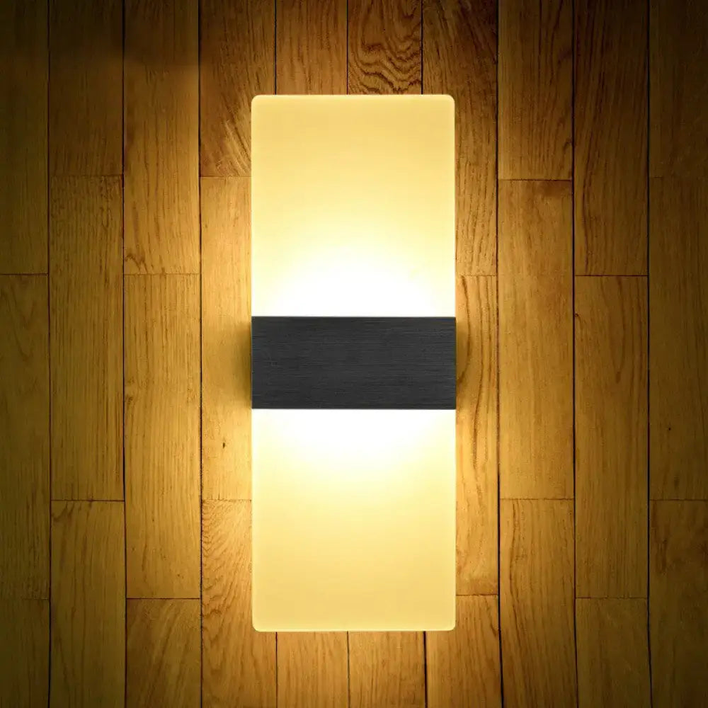 Modern geometric wood and acrylic wall sconce lamp with warm glow and black accent strip for bedroom wall lighting