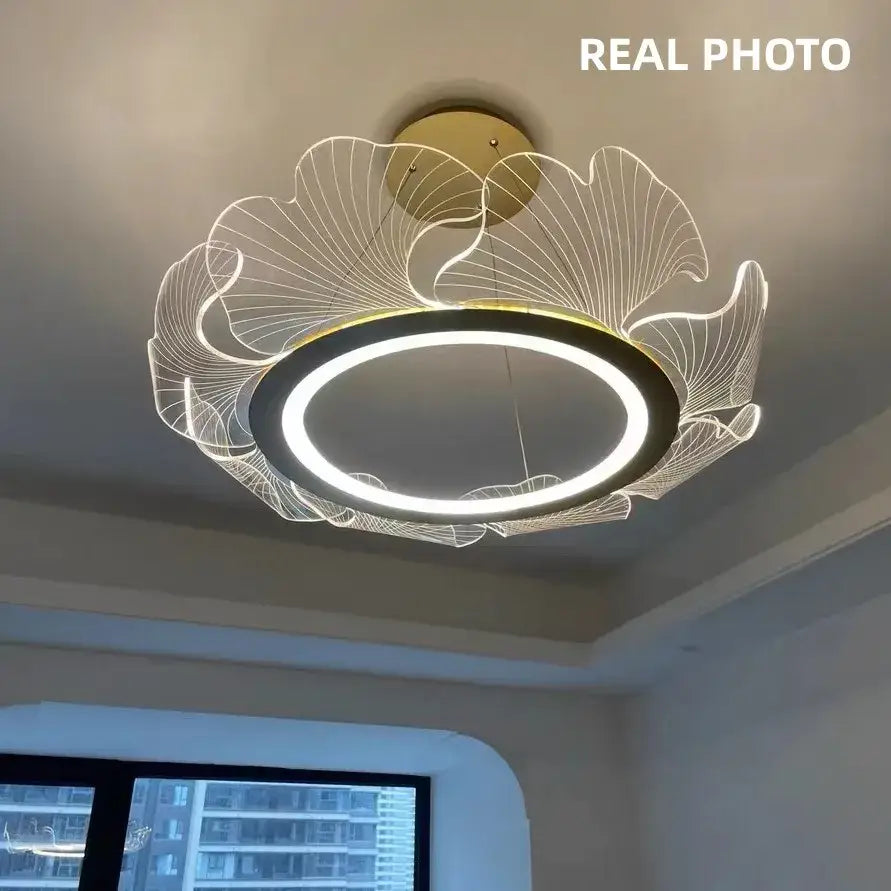 Modern ginkgo gold acrylic pendant light with gold-toned circular led ring and illuminated leaf wireframe design for dining room