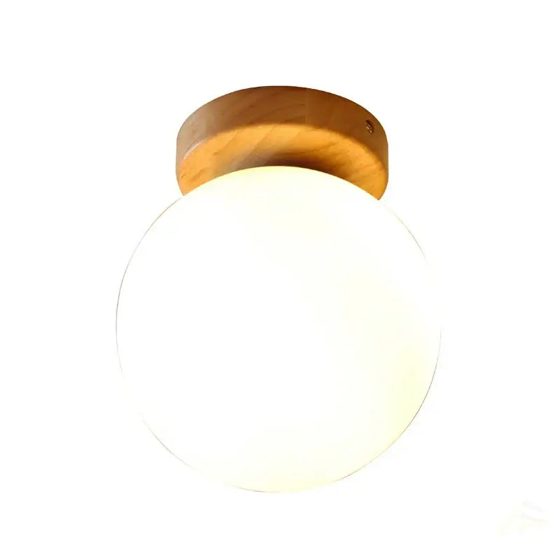 Modern glass ball led ceiling lamp featuring a warm-toned wooden mount and frosted glass globe for bedroom decorbites decor