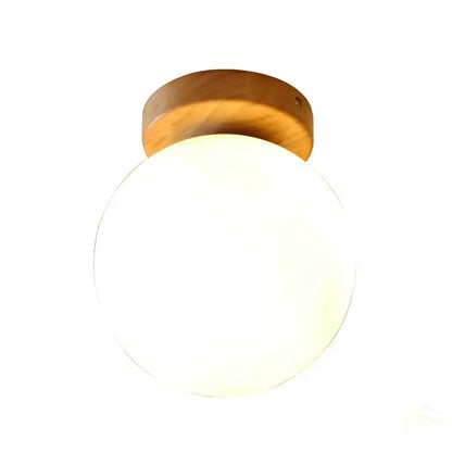 Modern glass ball led ceiling lamp featuring a warm-toned wooden mount and frosted glass globe for bedroom decorbites decor