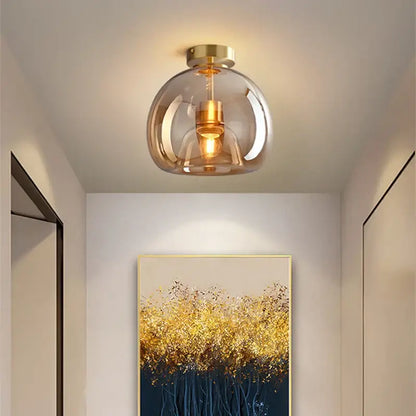 Modern ceiling light with a smoked glass ball led globe and gold-toned brass accents for bedroom decorbites lighting