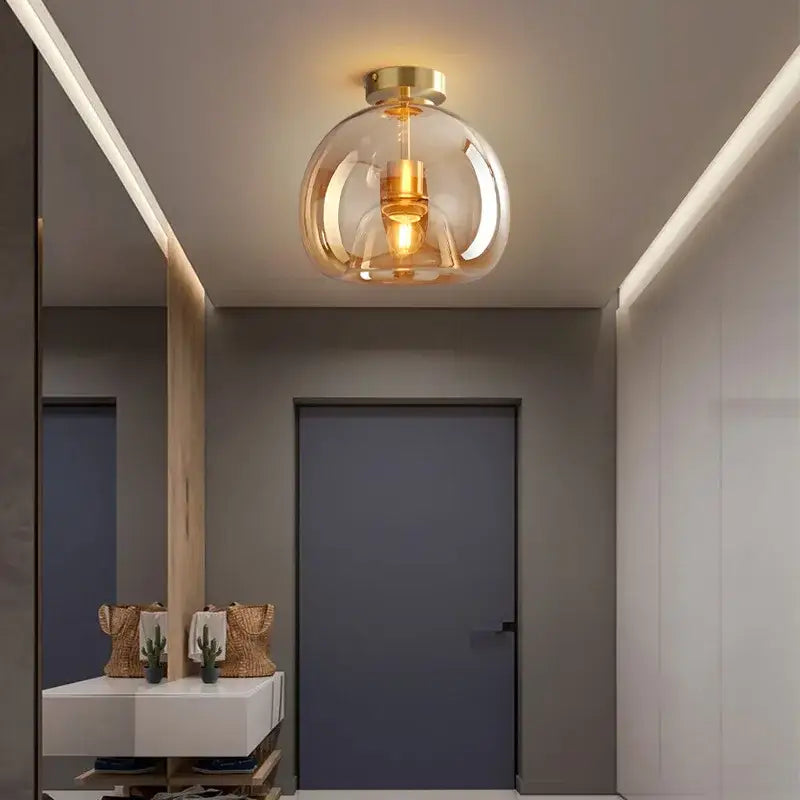 Modern glass ball led ceiling light with brass finish and warm ambient glow for bedroom decorbites lighting