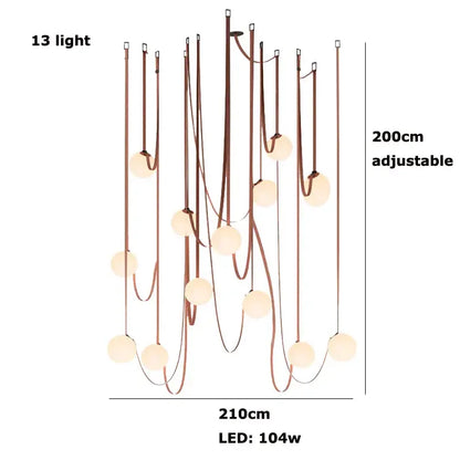 A modern black and orange decorbites glass ball led pendant light with 13 warm spherical lights and copper frame