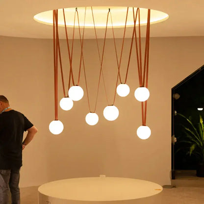 Modern glass ball led pendant light with seven white spherical bulbs on brown leather cords for living room decorbites decor