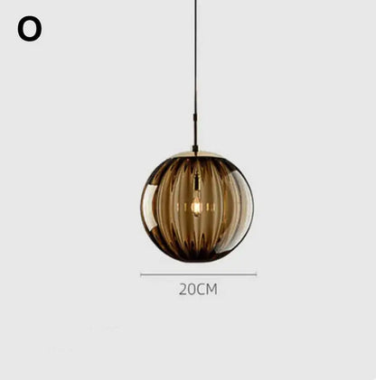 A sleek amber glass ball lustre pendant light with vertical ridges and visible filament bulb for modern decorbites pendant lights