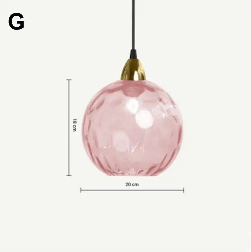 A delicate pink decorbites glass ball lustre pendant light with faceted texture and gold-toned fixture for kitchen decor