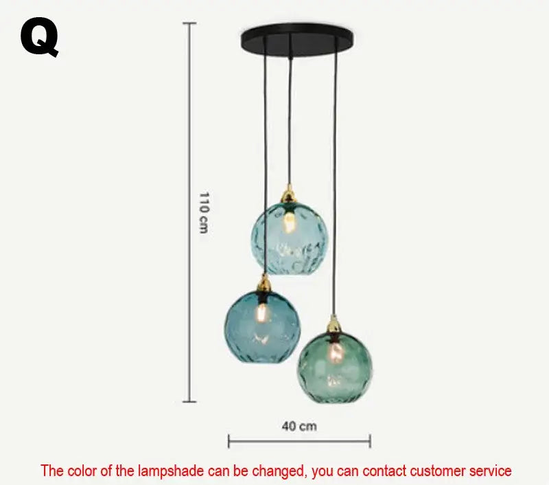 Set of three pendant lights with textured teal glass ball lustre shades and gold-toned fixtures for kitchen decorbites