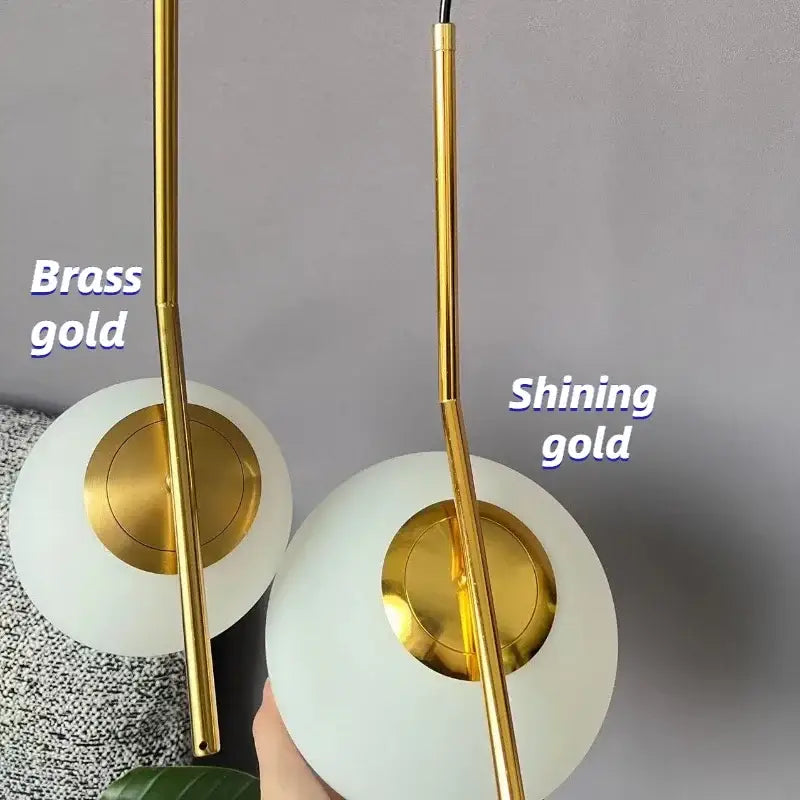 Modern glass ball pendant light with sleek brass gold rods and frosted glass shades for dining room decorbites glass ball pendant