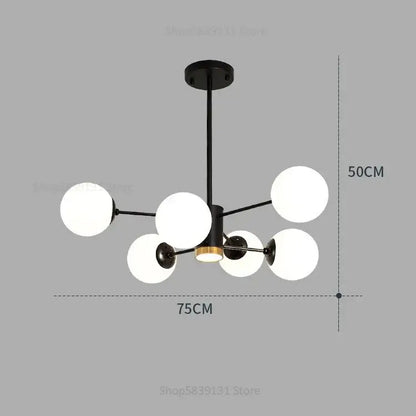 Modern black metal chandelier with six frosted glass ball pendant lights and central brass accent for living room decorbites glass ball