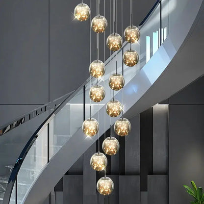 A modern glass ball spiral chandelier with multiple warm gold glass globes suspended by metallic chains for dining room decorbites