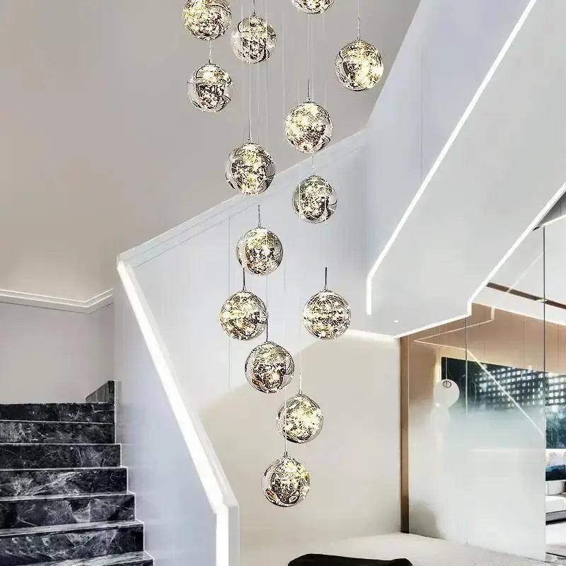 A modern decorbites glass ball spiral chandelier with metallic spherical glass orbs for dining room pendant lighting