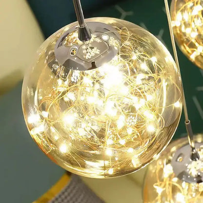 Modern glass ball spiral chandelier featuring a golden spherical pendant with intricate string lights inside clear glass