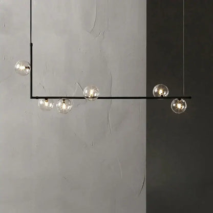 Modern glass black chandelier featuring five clear glass globe bulbs and gold accents for dining room decorbites glass black