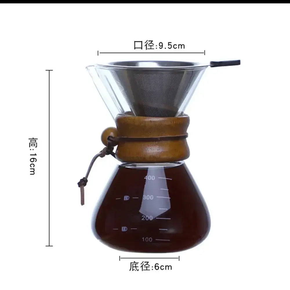 A modern glass coffee kettle set with wooden collar and steel filter drip featuring measurement markings on the bulbous base